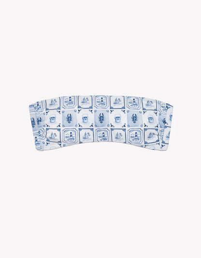 Bandeau top with blue and white pattern on a white background.