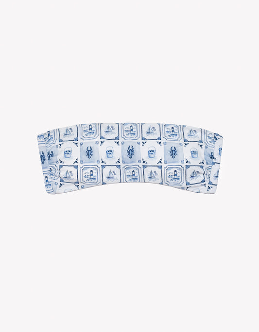 Bandeau top with blue and white pattern on a white background.